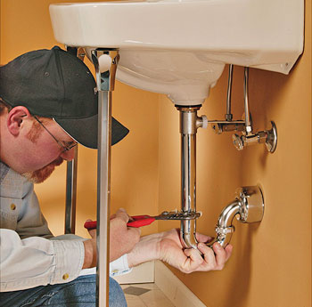 sink repairs and pipe fix's one of our Tracy plumbing contractors repairing a sink plumbing problem